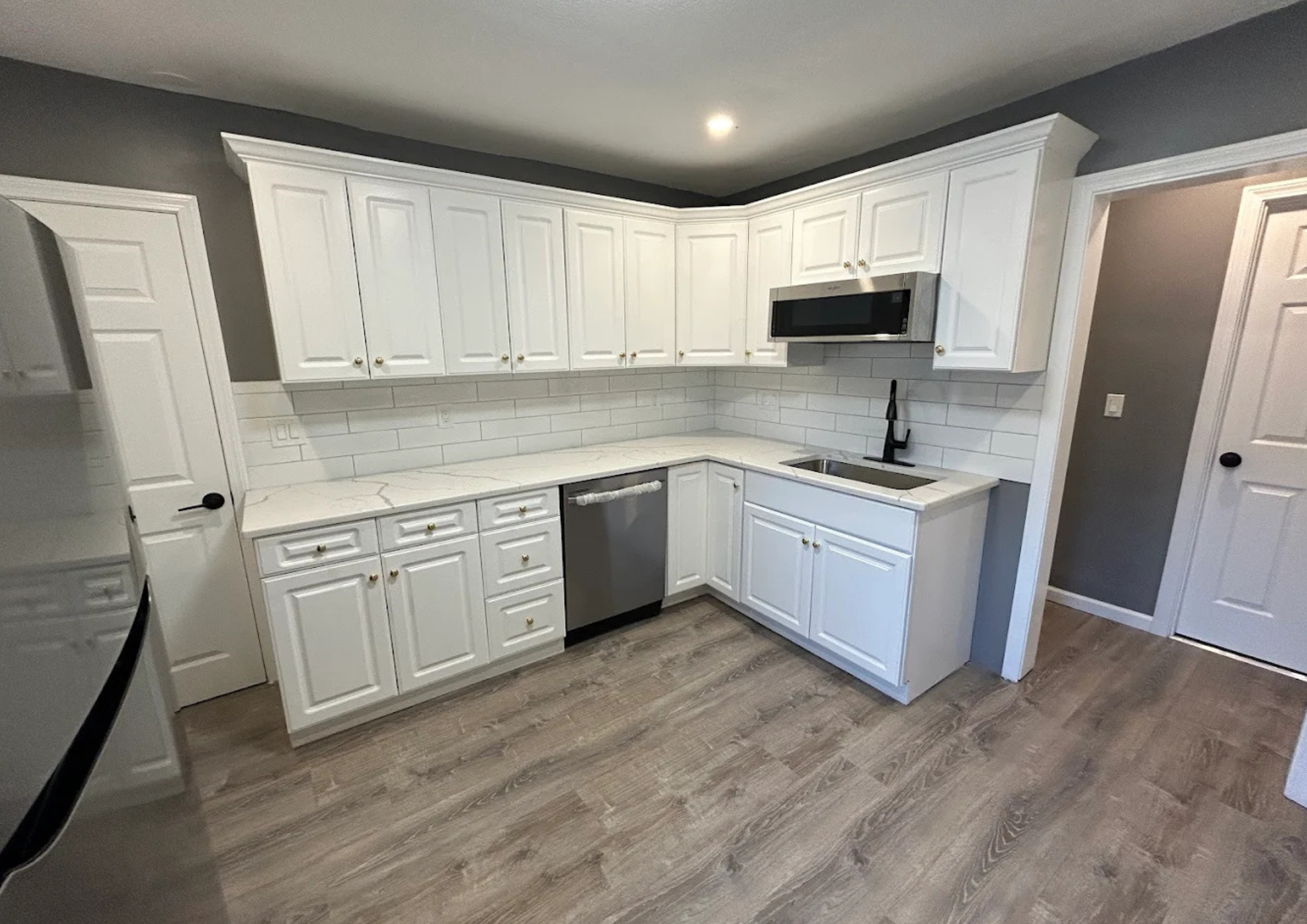 Refinished white kitchen cabinets with smooth finish