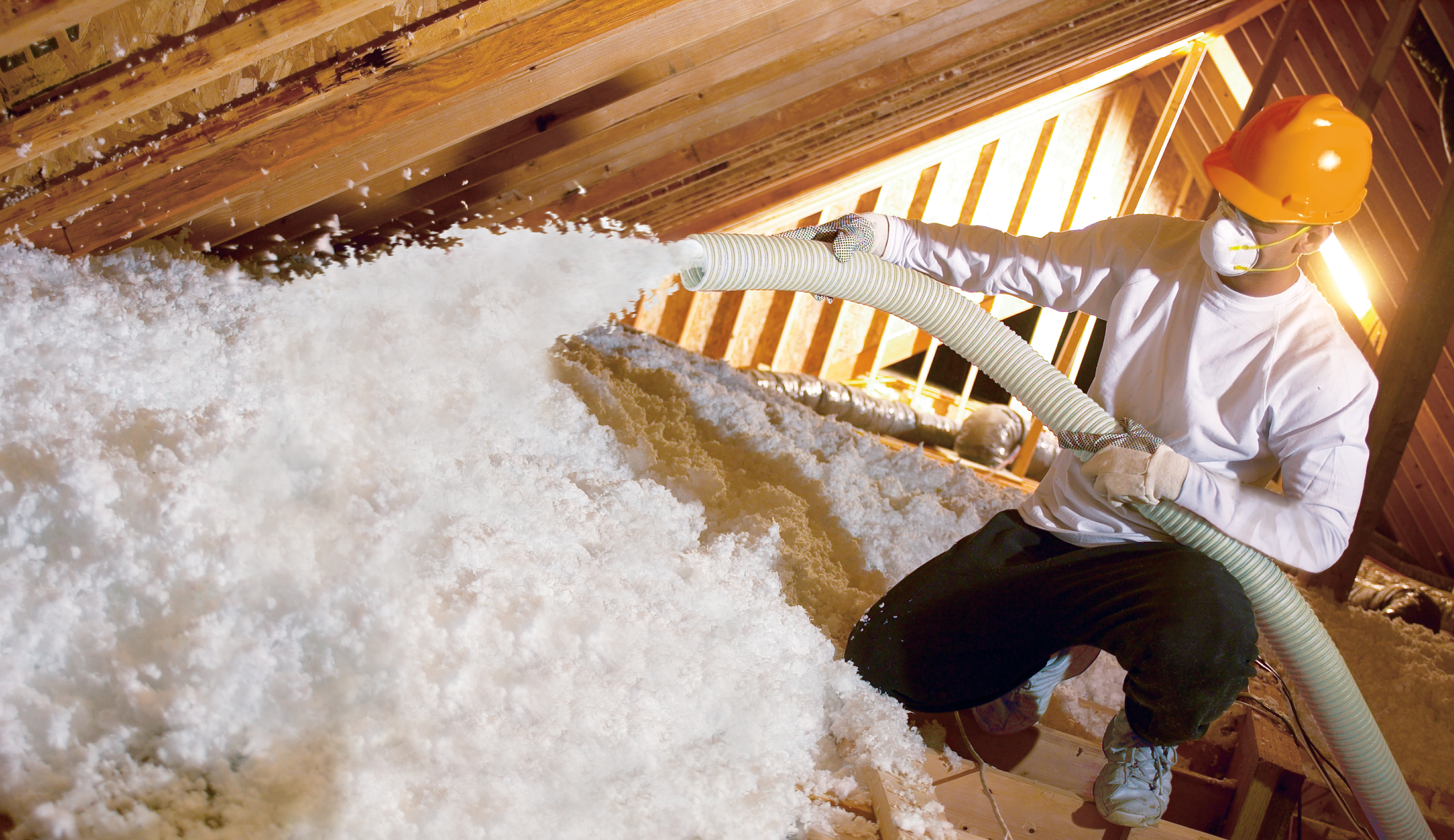 Blow-in insulation being applied in an attic